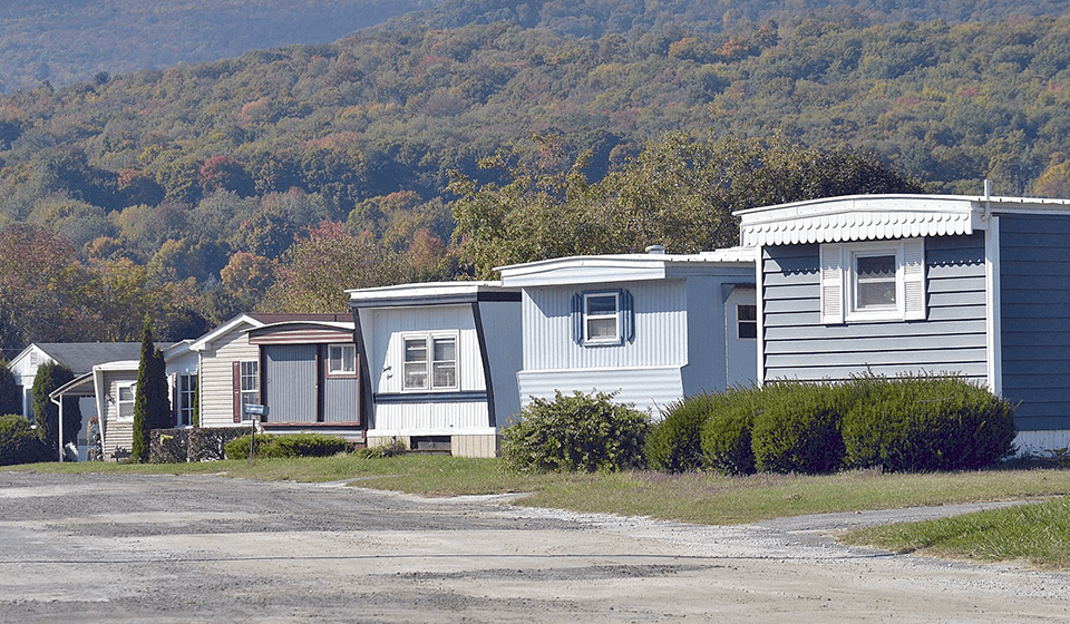 A row of mobile homes in the middle of nowhere.