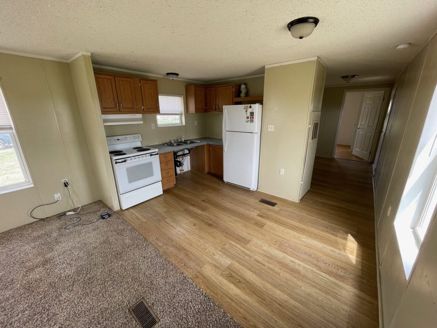 Kitchen and living area of a mobile home.