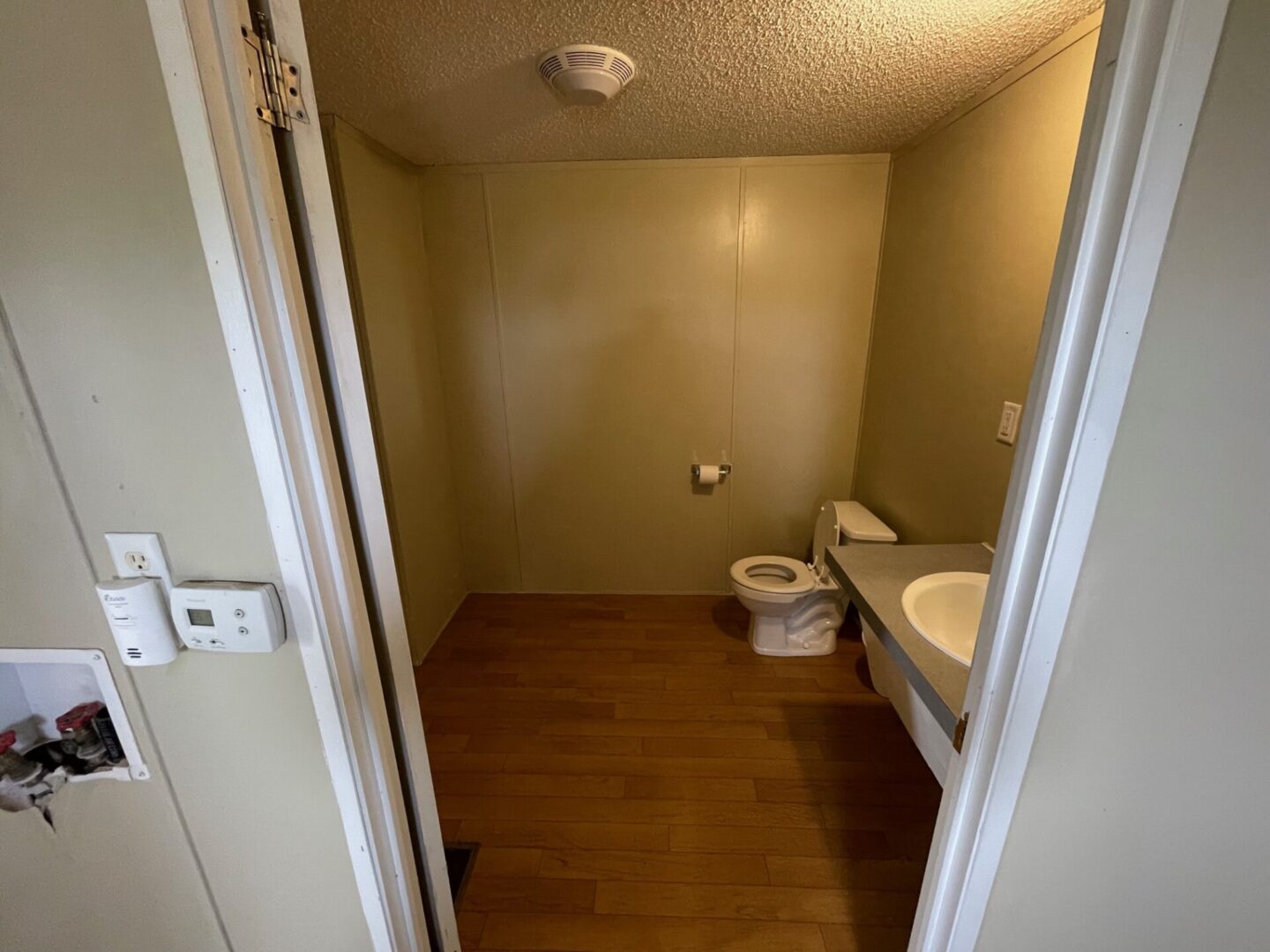 A view of a bathroom with a toilet and sink.